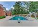 Backyard pool with a diving board, a slide, and an outdoor seating area, surrounded by a fenced yard at 3217 Aberrone Pl, Buford, GA 30519