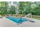 Backyard pool featuring a slide, diving board, and a cozy firepit area, perfect for outdoor entertaining at 3217 Aberrone Pl, Buford, GA 30519