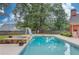 Backyard pool features a slide, diving board, and in-ground spa with a brick surround at 3217 Aberrone Pl, Buford, GA 30519