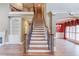 The front entry hall shows the staircase with wrought iron spindles and the formal dining room at 3217 Aberrone Pl, Buford, GA 30519