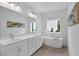 Bathroom featuring double vanity, soaking tub, and a large window allowing for lots of natural light at 3508 Mount Blue Ave, Tucker, GA 30084