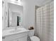 Well-lit bathroom featuring a shower with a curtain, mirror and vanity at 3508 Mount Blue Ave, Tucker, GA 30084