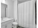 Bright bathroom featuring a white vanity, toilet, and shower with a white shower curtain at 3508 Mount Blue Ave, Tucker, GA 30084