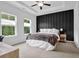 Bright bedroom featuring a decorative accent wall, ceiling fan, desk, and two large windows at 3508 Mount Blue Ave, Tucker, GA 30084