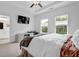 Bright bedroom featuring a ceiling fan, desk, two large windows, and an adjoining bathroom at 3508 Mount Blue Ave, Tucker, GA 30084