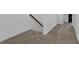 Staircase featuring carpeted steps, white walls, and a brown handrail at 3508 Mount Blue Ave, Tucker, GA 30084