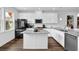 Contemporary kitchen boasting white cabinets, an island with bar stools, and stainless steel appliances at 3508 Mount Blue Ave, Tucker, GA 30084