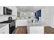 Bright kitchen features stainless steel appliances, white cabinets, granite countertops and hardwood flooring at 3508 Mount Blue Ave, Tucker, GA 30084