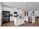 Modern kitchen featuring an island, stainless appliances, granite countertops, white cabinets, and hardwood floors at 3508 Mount Blue Ave, Tucker, GA 30084