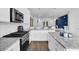Bright kitchen features stainless steel appliances, white cabinets, granite countertops and hardwood flooring at 3508 Mount Blue Ave, Tucker, GA 30084
