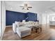 Spacious living room boasts dark accent wall, hardwood flooring and plenty of natural light at 3508 Mount Blue Ave, Tucker, GA 30084