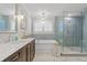 Bright bathroom with double sink vanity, soaking tub, glass shower, and tiled walls at 480 Wimbledon Ne Rd, Atlanta, GA 30324