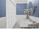 Charming bathroom featuring a marble countertop, white vanity, and a framed mirror at 480 Wimbledon Ne Rd, Atlanta, GA 30324