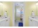 Bathroom with double vanity, tile flooring, and patterned shower curtain at 480 Wimbledon Ne Rd, Atlanta, GA 30324