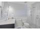 Stylish bathroom with a glass enclosed shower, elegant fixtures, and blue striped wallpaper at 480 Wimbledon Ne Rd, Atlanta, GA 30324