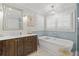 Elegant bathroom featuring a soaking tub, white marble countertop, and refined finishes at 480 Wimbledon Ne Rd, Atlanta, GA 30324