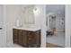 Bathroom featuring a vanity with marble countertop and decorative mirror, leading to the bedroom at 480 Wimbledon Ne Rd, Atlanta, GA 30324