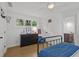 Bedroom with wood floors, ceiling fan, paneled doors, dark wood dresser and ensuite bath at 480 Wimbledon Ne Rd, Atlanta, GA 30324