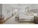 Bedroom featuring white walls, wood floors, king size bed, and sliding barn door at 480 Wimbledon Ne Rd, Atlanta, GA 30324