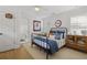 Bedroom with wood floors, ceiling fan, paneled doors, a bed and an accent cabinet at 480 Wimbledon Ne Rd, Atlanta, GA 30324