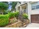 Inviting front entrance features stone steps, black iron railing and lush landscaping at 480 Wimbledon Ne Rd, Atlanta, GA 30324