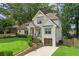 Beautiful two-story home featuring a lush lawn and a driveway leading to a garage at 480 Wimbledon Ne Rd, Atlanta, GA 30324