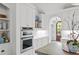 Kitchen showcasing white cabinetry, stainless steel appliances, and hardwood floors at 480 Wimbledon Ne Rd, Atlanta, GA 30324