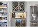 Kitchen bar with beverage fridge, marble countertop, pantry, and stainless steel refrigerator at 480 Wimbledon Ne Rd, Atlanta, GA 30324