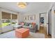 Cozy sitting room featuring a comfortable gray couch and a bright window view at 480 Wimbledon Ne Rd, Atlanta, GA 30324