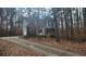 Charming two-story home nestled among mature trees and a private drive at 488 Morris Rd, Hiram, GA 30141