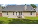 Well-maintained backyard with patio, dining set, and green grass at 4920 Markim Forest Ln, Sugar Hill, GA 30518