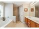 Bathroom with double vanity, soaking tub, and a separate shower at 4920 Markim Forest Ln, Sugar Hill, GA 30518