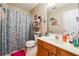 Functional bathroom featuring a vanity, toilet, mirror and shower with curtain at 4920 Markim Forest Ln, Sugar Hill, GA 30518