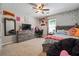 Comfortable bedroom featuring a large bed, dresser, and a cozy reading nook at 4920 Markim Forest Ln, Sugar Hill, GA 30518