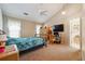 Bright bedroom featuring carpet flooring, a ceiling fan, and a spacious closet at 4920 Markim Forest Ln, Sugar Hill, GA 30518