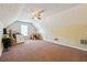 Spacious bonus room with carpeted floor, window, sloped ceiling, and ceiling fan at 4920 Markim Forest Ln, Sugar Hill, GA 30518