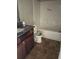 Compact bathroom featuring a vanity with a granite countertop, a white toilet, and a tub-shower combination at 1900 Old Dogwood, Jonesboro, GA 30238