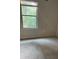 Neutral bedroom features carpeted floors and a window providing natural light at 1900 Old Dogwood, Jonesboro, GA 30238