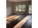 Open-concept dining area with hardwood floors and natural light filtering through the large window and glass patio door at 1900 Old Dogwood, Jonesboro, GA 30238