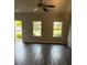Inviting living room featuring rich hardwood floors and natural light streaming through two large windows at 1900 Old Dogwood, Jonesboro, GA 30238