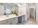 Bright bathroom with double vanity, large mirror, and stylish lighting fixtures at 939 Brittfield Way, Loganville, GA 30052