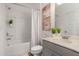 Bright, clean bathroom featuring a shower-tub combo, vanity with plants, and neutral decor at 939 Brittfield Way, Loganville, GA 30052