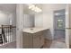 Bathroom vanity area with white countertop, cabinets, and large mirror with bright lighting at 939 Brittfield Way, Loganville, GA 30052