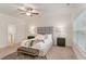 Spacious bedroom with ceiling fan, large window, and ensuite bathroom at 939 Brittfield Way, Loganville, GA 30052