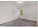 A bedroom with neutral carpet and white walls centered on one window at 939 Brittfield Way, Loganville, GA 30052