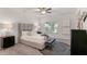 Bright primary bedroom boasts stylish decor, a ceiling fan, and modern accents at 939 Brittfield Way, Loganville, GA 30052