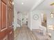 Bright entryway features wood floors, a staircase, and an open view into the dining area at 939 Brittfield Way, Loganville, GA 30052