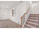 Entryway features wood floors, a staircase, and access to front door at 939 Brittfield Way, Loganville, GA 30052