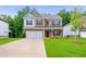 Charming two-story home with a well-manicured lawn and a spacious driveway at 939 Brittfield Way, Loganville, GA 30052