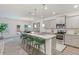Modern kitchen boasts granite countertops, stainless steel appliances, island with bar stool seating and pendant lighting at 939 Brittfield Way, Loganville, GA 30052